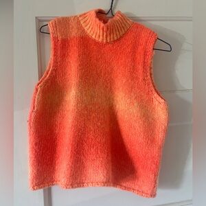 Bright orange sleeveless knit sweater.